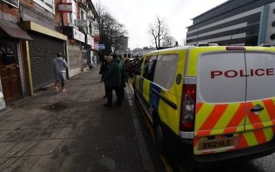 A police van is parked outside a residential building in Birmingham which was raided by anti-terror forces in the early hours on March 23, 2017. (AFP Photo/Paul Ellis)