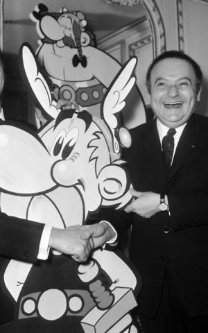 French comic book artists Albert Uderzo, left, and René Goscinny present models of the characters of Asterix during a reception at the Maxim's restaurant in Paris before the release of the cartoon, November 16, 1967. (AFP)