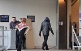 A person assumed to be Bob Dylan, wearing a black jacket and a hoodie, enters the backstage door at Stockholm Waterfront April 1, 2017 (AFP PHOTO / TT News Agency / Jessica GOW)