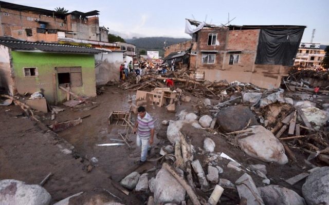 People walk through the rubble left by mudslides following heavy rains in Mocoa, Putumayo department, southern Colombia on April 1, 2017 (AFP PHOTO / LUIS ROBAYO) People walk through the rubble left by mudslides following heavy rains in Mocoa, Putumayo department, southern Colombia on April 1, 2017 (AFP PHOTO / LUIS ROBAYO)