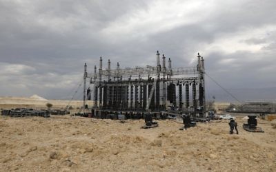 Workers prepare the stage for French electronic music pioneer Jean-Michel Jarre ahead of his upcoming concert to publicise the plight of the shrinking Dead Sea at the ancient clifftop fortress of Masada, on April 2, 2017. (Menahem Kahana/AFP) Workers prepare the stage for French electronic music pioneer Jean-Michel Jarre ahead of his upcoming concert to publicise the plight of the shrinking Dead Sea at the ancient clifftop fortress of Masada, on April 2, 2017. (Menahem Kahana/AFP)