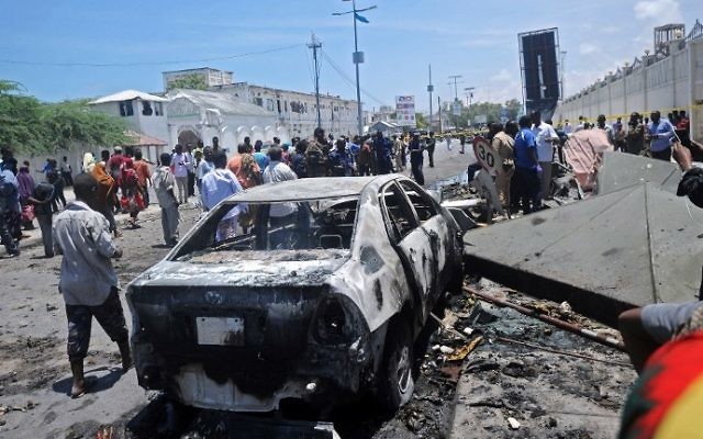 Illustrative: People stand at the site of a car bomb near a restaurant near the Somali ministry of internal security in Mogadishu on April 5, 2017. (AFP Photo/Mohamed Abdiwahab) Illustrative: People stand at the site of a car bomb near a restaurant near the Somali ministry of internal security in Mogadishu on April 5, 2017. (AFP Photo/Mohamed Abdiwahab)