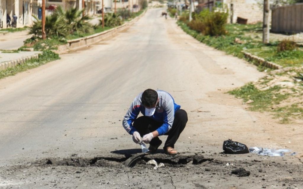 A Syrian man collects samples from the site of a suspected toxic gas attack in Khan Sheikhoun, in Syria's northwestern Idlib province, on April 5, 2017. (AFP/Omar Haj Kadour) A Syrian man collects samples from the site of a suspected toxic gas attack in Khan Sheikhoun, in Syria's northwestern Idlib province, on April 5, 2017. (AFP/Omar Haj Kadour)