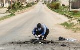 A Syrian man collects samples from the site of a suspected toxic gas attack in Khan Sheikhoun, in Syria's northwestern Idlib province, on April 5, 2017. (AFP/Omar Haj Kadour)