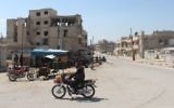 A Syrian man rides his motorcycle in Khan Sheikhun on April 7, 2017 near the area of a suspected chemical weapons attack earlier this week on the northwestern Syrian town that killed at least 86 people. (AFP/Omar Haj Kadour)