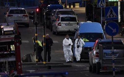 Forensics Police officers work at the scene where a truck slammed into a crowd of people outside a busy department store in central Stockholm, causing "deaths" in what the prime minister described as a 'terror attack' on April 7, 2017.  (AFP/ Jonathan NACKSTRAND)