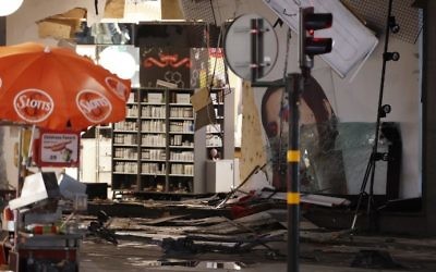 Damage to a store is revealed after the stolen truck, which was driven through a crowd outside a department in Stockholm on April 7, 2017, was taken away on April 8. (AFP Photo/Odd Andersen)
