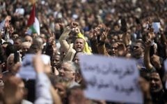 Palestinian Authority employees chant slogans and wave placards during a demonstration against the decision by the PA to reduce their salaries in Gaza City on April 8, 2017. (AFP Photo/Mahmud Hams)