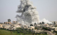 Illustrative: Smoke billows following a reported air strike on a rebel-held area in the southern Syrian city of Daraa, on April 8, 2017. (Mohamad Abazeed/AFP)