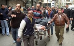Egyptians wheel away a body near a church in Alexandria after a bomb blast struck worshippers gathering to celebrate Palm Sunday on April 9, 2017. (AFP Photo/Stringer)