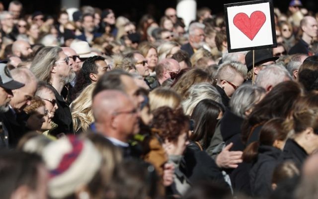 People attend a memorial ceremony at Sergels Torg plaza in Stockholm, Sweden on April 9, 2017 close to the point where a truck drove into a department store two days before. (AFP PHOTO / Odd ANDERSEN)