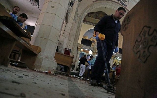 A general view shows forensics collecting evidence at the site of a bomb blast which struck worshippers gathering to celebrate Palm Sunday at the Mar Girgis Coptic Church in the Nile Delta City of Tanta on April 9, 2017. (AFP/STRINGER) A general view shows forensics collecting evidence at the site of a bomb blast which struck worshippers gathering to celebrate Palm Sunday at the Mar Girgis Coptic Church in the Nile Delta City of Tanta on April 9, 2017. (AFP/STRINGER)
