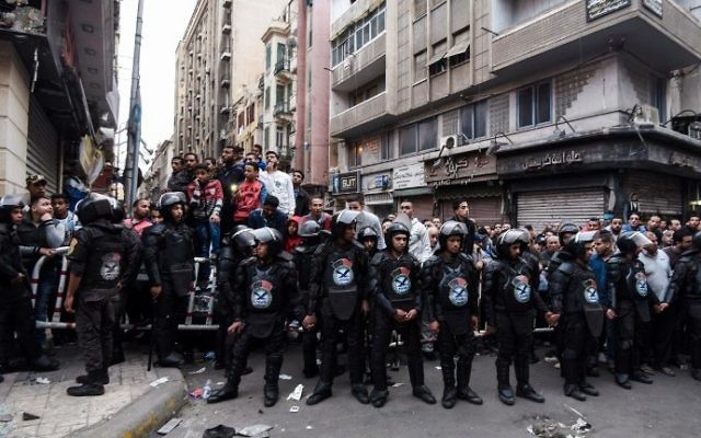 Egyptians gather behind a security perimeter near the Coptic Orthodox Patriarchate in Alexandria after a bomb blast struck outside the church as worshippers attended Palm Sunday mass on April 9, 2017. (AFP PHOTO / MOHAMED EL-SHAHED) Egyptians gather behind a security perimeter near the Coptic Orthodox Patriarchate in Alexandria after a bomb blast struck outside the church as worshippers attended Palm Sunday mass on April 9, 2017. (AFP PHOTO / MOHAMED EL-SHAHED)
