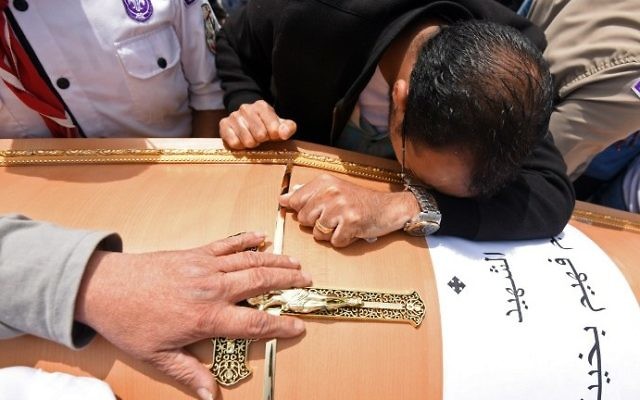 Men mourn over the coffin of one of the victims of the April 9, 2017 blast at the Coptic Christian Saint Mark's Church in Alexandria, Egypt, during a funeral procession at the Monastery of Marmina in the city of Borg El-Arab, east of Alexandria, on April 10, 2017. (AFP Photo/Mohamed El-Shahed)
