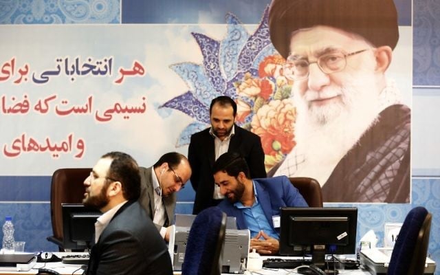 Iranians arrive to the interior ministry's election headquarters as candidates begin to sign up for the upcoming presidential elections in Tehran on April 11, 2017. (AFP/ATTA KENARE)