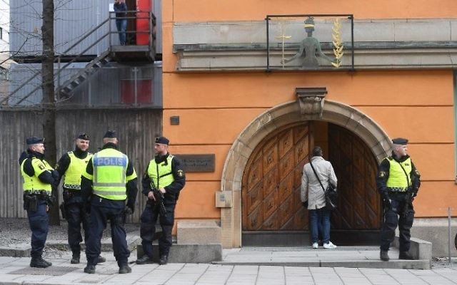 Policemen secure the entrance to the Stockholm District Court where Uzbek national Rakhmat Akilov, prime suspect in the Stockholm truck attack, appeared in court on April 11, 2017. (AFP Photo/TT News Agency/Fredrik Sandberg)
