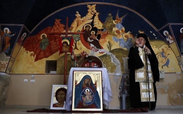Archbishop Joseph Jules Zerey of the Melkite Greek Catholic Church blesses foreign students of the Bethlehem Icon Center as they present the works executed during their course, in the biblical West Bank city of Bethlehem on April 11, 2017. (AFP PHOTO / THOMAS COEX) Archbishop Joseph Jules Zerey of the Melkite Greek Catholic Church blesses foreign students of the Bethlehem Icon Center as they present the works executed during their course, in the biblical West Bank city of Bethlehem on April 11, 2017. (AFP PHOTO / THOMAS COEX)