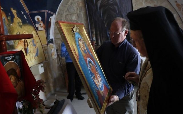 Archbishop Joseph Jules Zerey (R) of the Melkite Greek Catholic Church blesses foreign students of the Bethlehem Icon Center as they present the works executed during their course, in the biblical West Bank city of Bethlehem on April 11, 2017. (AFP PHOTO / THOMAS COEX) Archbishop Joseph Jules Zerey (R) of the Melkite Greek Catholic Church blesses foreign students of the Bethlehem Icon Center as they present the works executed during their course, in the biblical West Bank city of Bethlehem on April 11, 2017. (AFP PHOTO / THOMAS COEX)