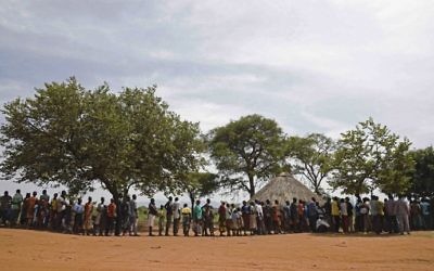 Newly arrived refugees from South Sudan wait in line to be registered on April 11, 2017 at Ngomoromo border post to be transferred into a resettlement Centre. (AFP Photo/Isaac Kasamani)