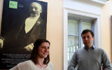 Przemyslaw Wierzbowski, Esperanto association president in the eastern Polish city of Bialystok and French student Amelie Chartier, who came to Bialystok to work at the Esperanto association through a European volunteer program stand in the Esperanto Cafe in front of the portrait of Ludwik Zamenhof on April 5, 2017. Zamenhof, the creator of the synthetic language of Esperanto, was born in 1859 just a few steps away from where the cafe is located. (JANEK SKARZYNSKI / AFP)