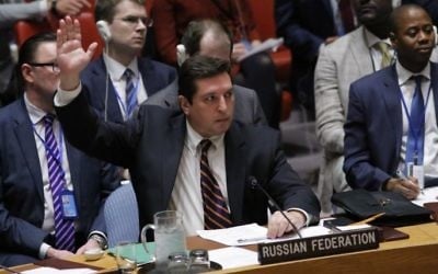 Russian Deputy Permanent Representative to the United Nations Vladimir Safronkov holds up his hand as he votes against a draft resolution that condemned the reported use of chemical weapons in Syria during a meeting at the UN Headquarters in New York, April 12, 2017. (AFP/KENA BETANCUR)