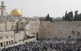 Jewish people take part in the priestly blessing ceremony during the Passover holiday at the Western Wall in the Old City of Jerusalem on April 13, 2017. (AFP Photo/Thomas Coex)