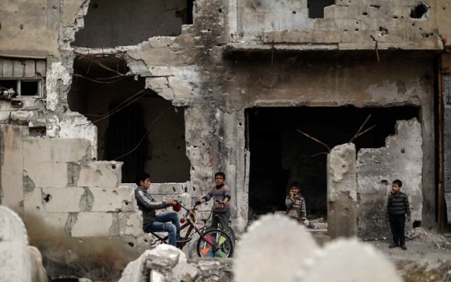 Syrian boys ride bikes amid destroyed buildings in the rebel-held town of Douma, on the eastern outskirts of the Syrian capital Damascus, on April 13, 2017. (AFP/Sameer Al-Doumy) Syrian boys ride bikes amid destroyed buildings in the rebel-held town of Douma, on the eastern outskirts of the Syrian capital Damascus, on April 13, 2017. (AFP/Sameer Al-Doumy)