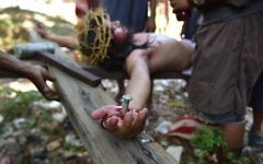 A penitent acting as Jesus is nailed to the cross as they re-enact the passion and death of Christ during the annual observance of Lent on Good Friday in Cainta town, Rizal province, east of Manila on April 14, 2017.  (Ted Aljibe/AFP)