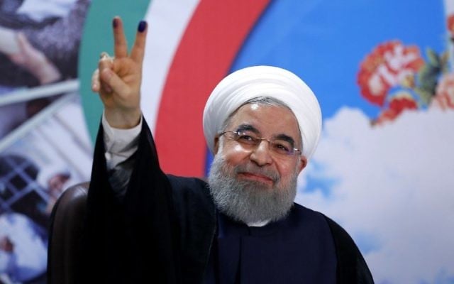 Iranian President Hassan Rouhani gestures to the camera after registering to run for re-election at the interior ministry in the capital Tehran on April 14, 2017 (AFP PHOTO / ISNA / ATTA KENARE)