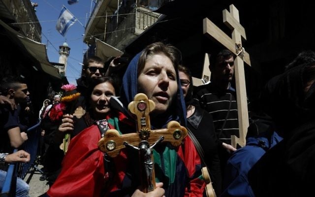 Christian pilgrims carry wooden crosses along the path where Jesus walked, now known as the Via Dolorosa, or the Way of Suffering, in Jerusalem's Old City, on Good Friday, April 14, 2017. (AFP/ GALI TIBBON)