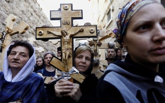 Christian pilgrims carry wooden crosses along the path where Jesus walked, now known as the "Via Dolorosa", or the "Way of Suffering", on Good Friday in Jerusalem's Old City on April 14, 2017.
(AFP/ GALI TIBBON)