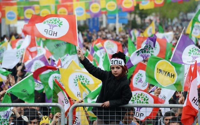 A young woman waves a HDP party flag as Kurdish people attend a rally of the opposition pro-Kurdish Peoples' Democratic Party (HDP), on the eve of the constitutional referendum, on April 15, 2017 in Diyarbakir. (AFP PHOTO / ILYAS AKENGIN)