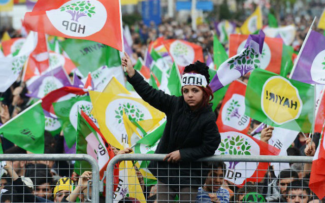 A young woman waves an HDP party flag as Kurdish people attend a rally of the opposition pro-Kurdish Peoples' Democratic Party (HDP), on the eve of the constitutional referendum, on April 15, 2017 in Diyarbakir, Turkey. (Ilyas Akengin/AFP)