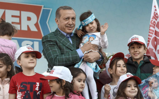 Turkish President Recep Tayyip Erdogan poses with children after a rally on April 15, 2017, in Istanbul on the eve of the constitutional referendum. (Ozan Kose/AFP) Turkish President Recep Tayyip Erdogan poses with children after a rally on April 15, 2017, in Istanbul on the eve of the constitutional referendum. (Ozan Kose/AFP)