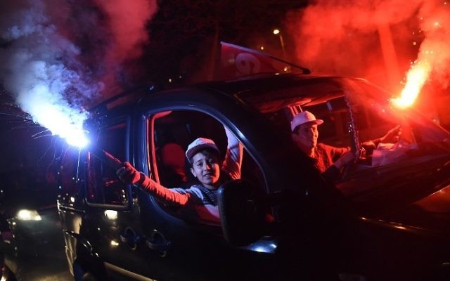 Supporters of the "yes" side gesture with smoke bombs from outside of a car window as they drive by the headquarters of the conservative Justice and Development Party (AKP) on April 16, 2017 in Istanbul.
(AFP Photo/Ozan Kose) Supporters of the "yes" side gesture with smoke bombs from outside of a car window as they drive by the headquarters of the conservative Justice and Development Party (AKP) on April 16, 2017 in Istanbul.
(AFP Photo/Ozan Kose)