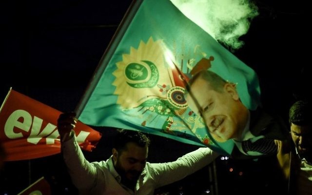 A supporter of the "yes" side waves a flag depicting Turkish President Recep Tayyip Erdogan during a rally near the headquarters of the conservative Justice and Development Party (AKP) on April 16, 2017 in Istanbul. (AFP Photo/Ozan Kose) A supporter of the "yes" side waves a flag depicting Turkish President Recep Tayyip Erdogan during a rally near the headquarters of the conservative Justice and Development Party (AKP) on April 16, 2017 in Istanbul. (AFP Photo/Ozan Kose)