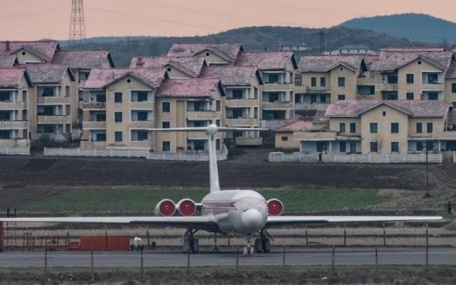 Illustrative: An Air Koryo aircraft sits parked in front of houses outside Pyongyang airport on April 17, 2017. (AFP Photo/Ed Jones) Illustrative: An Air Koryo aircraft sits parked in front of houses outside Pyongyang airport on April 17, 2017. (AFP Photo/Ed Jones)