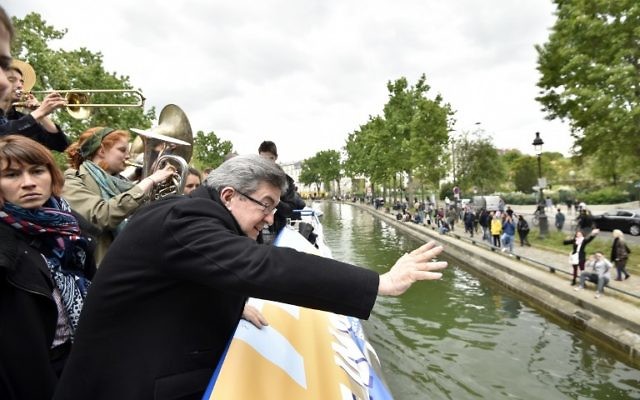 French presidential election candidate for the far-left coalition La France insoumise Jean-Luc Melenchon, greets people from aboard an "unbowed" barge on the Canal Saint-Martin on April 17, 2017 in Paris, as part of his campaign. (AFP PHOTO / POOL / ALAIN JOCARD)