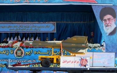 An Iranian military truck with a picture of President Hassan Rouhan carries a rocket and displays a banner reading "Death to Israel" during a parade marking the country's National Army Day, in Tehran, April 18, 2017. (AFP/Atta Kenare)