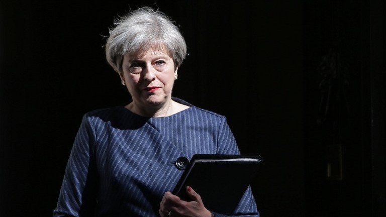 British Prime Minister Theresa May walks out of 10 Downing Street to make a statement to the media in central London on April 18, 2017. (AFP PHOTO / Daniel LEAL-OLIVAS) British Prime Minister Theresa May walks out of 10 Downing Street to make a statement to the media in central London on April 18, 2017. (AFP PHOTO / Daniel LEAL-OLIVAS)