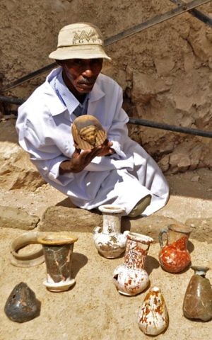 A member of an Egyptian archaeological team shows artifacts discovered in a 3,500-year-old tomb in the Draa Abul Nagaa necropolis, near the southern city of Luxor, April 18, 2017. (AFP/STRINGER) A member of an Egyptian archaeological team shows artifacts discovered in a 3,500-year-old tomb in the Draa Abul Nagaa necropolis, near the southern city of Luxor, April 18, 2017. (AFP/STRINGER)