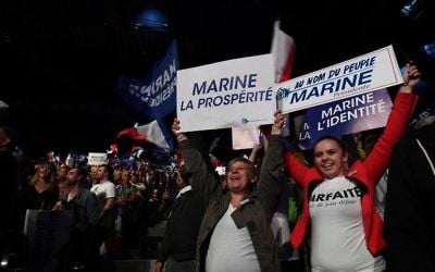 Supporters of French presidential election candidate for the far-right Front National (FN) party Marine Le Pen hold banners during a campaign meeting on April 19, 2017, in Marseille, southern France. (AFP PHOTO / ANNE-CHRISTINE POUJOULAT) Supporters of French presidential election candidate for the far-right Front National (FN) party Marine Le Pen hold banners during a campaign meeting on April 19, 2017, in Marseille, southern France. (AFP PHOTO / ANNE-CHRISTINE POUJOULAT)
