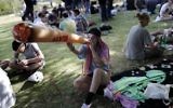 An Israeli girl poses with a mock marijuana joint in Jerusalem on April 20, 2017 during a rally at the Rose Garden, to celebrate 420 and to express their defiance of current laws. (AFP PHOTO / THOMAS COEX)