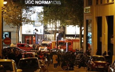 Illustrative: People stand behind a security zone as firefighters and rescuers wait near the site of a shooting at the Champs-Elysees in Paris, France, on April 20, 2017. (AFP/Benjamin Cremel)