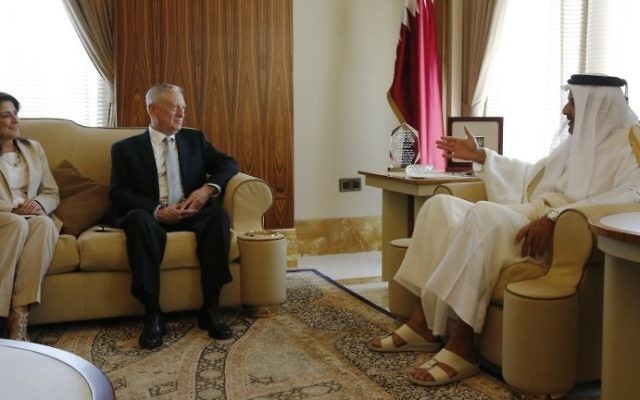 Qatar's Emir Sheikh Tamim bin Hamad al-Thani, right, welcomes US Defense Secretary James Mattis, center, and  US ambassador to Qatar, Dana Shell Smith, left, at the Prince's Sea Palace residence in Doha, on April 22, 2017. (AFP Photo/Pool/Jonathan Ernst)