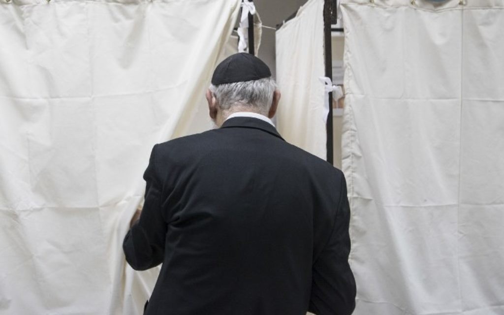 A French national residing in Israel prepares to cast his vote for the first round of the French presidential election on April 23, 2017, at the French consulate in the coastal city of Netanya. (AFP PHOTO / JACK GUEZ)