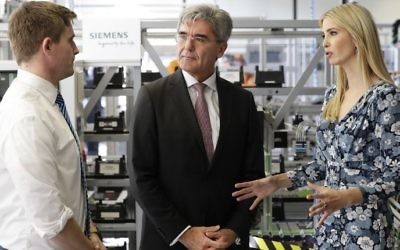 First Daughter and adviser to the US President Ivanka Trump talks with the chairman of Siemens Joe Kaeser (middle) and a trainee (L) during a visit of the Siemens Technik Akademie in Berlin on April 25, 2017. (Michael Sohn/AFP)