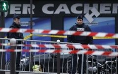 This file photo taken on January 10, 2015 shows French police officers standing guard in front of a kosher grocery store in Porte de Vincennes, eastern Paris, a day after four people were killed at the Jewish supermarket by jihadist gunman Amedy Coulibaly during a hostage-taking. (Kenzo Tribouillard/AFP)