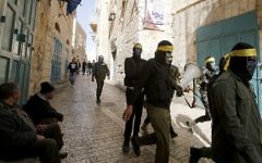 Shop owners sit outside their closed shops as Fatah movement supporters roam the streets of the West bank town of Bethlehem to control the general strike in support of Palestinian prisoners on hunger strike in Israeli jails on April 27, 2017. (Musa al-Shaer/AFP)