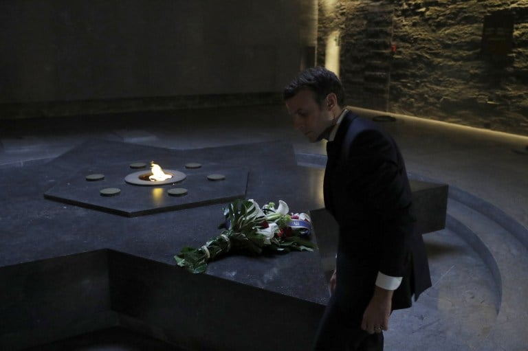 French presidential election candidate for the En Marche ! movement Emmanuel Macron stands in the Crypt of the Shoah Memorial on April 30, 2017 in Paris. (AFP PHOTO / POOL / PHILIPPE WOJAZER) French presidential election candidate for the En Marche ! movement Emmanuel Macron stands in the Crypt of the Shoah Memorial on April 30, 2017 in Paris. (AFP PHOTO / POOL / PHILIPPE WOJAZER)